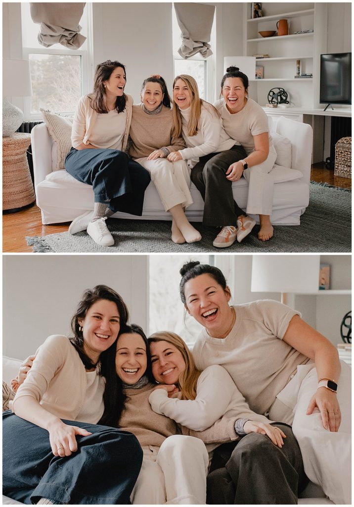 Four girls, all dressed in neutral outfits, pile onto a white couch in the living room of a beach cottage in Charlestown, Rhode Island. They are laughing and smiling.