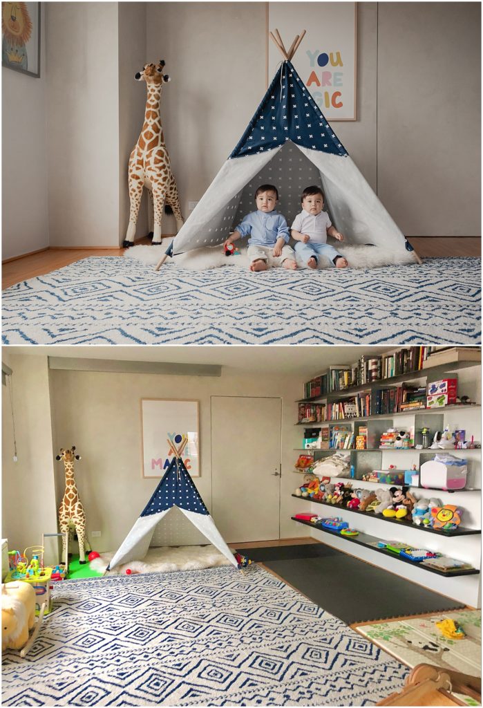 Two photos from the same apartment. The top photo is an edited camera photo of two twin boys sitting in a teepee in their living room. The floor is clean and the toys are perfectly curated. The bottom photo is an iphone pic of the real scene. It's slightly wider so you can see that the walls have floor-to-ceiling shelves that are covered in bright, plastic toys.