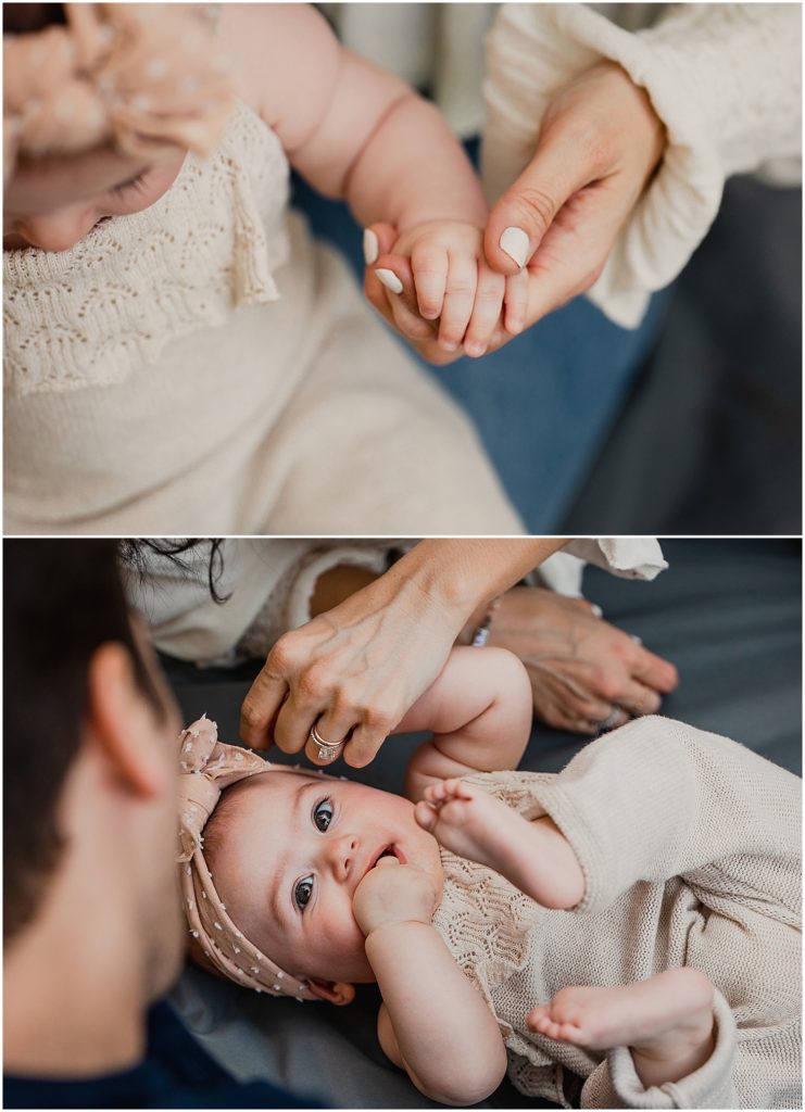 A lifestyle family photo session in Central Park in New York City. The top photo is a close up detail shot of a baby girl holding her mom's hand. The bottom photo is an overhead shot of the family on a blanket in Central Park. She looks up at the camera, still holding her mom's hand, as her dad looks at her lovingly. She chews on her free hand and tucks her legs up into the "Happy Baby" yoga pose.